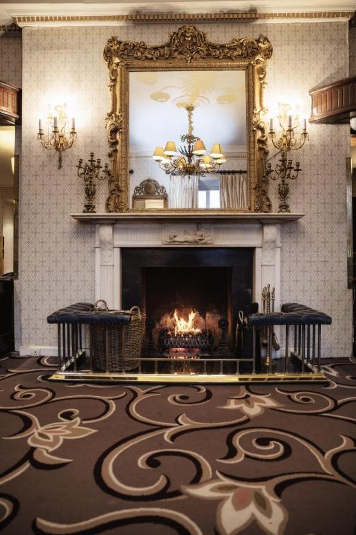 Fitzpatrick Castle Hotel - Lobby fireplace, gilt mirror